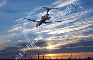 Boeing 717, (MD-80) landing at sunset dusk at LAX Los Angeles International Airport, Calfiornia.
