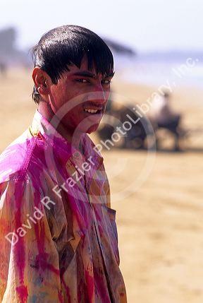 A young Indian man wearing Holi Festival colors in India.