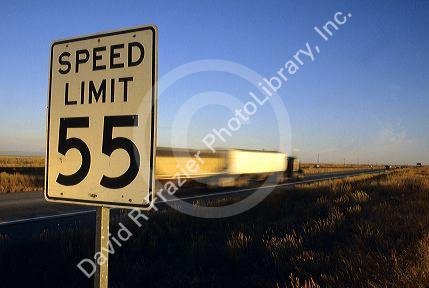 Speed limit 55 road sign with traffic on the interstate in Idaho.