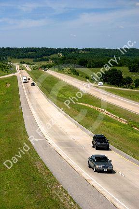 Automobiles travel on Interstate 40 near West Fork, Arkansas.

automobiles, cars, trucks, drive, travel, transportation, curve, interstate, road, arkansas, highway
