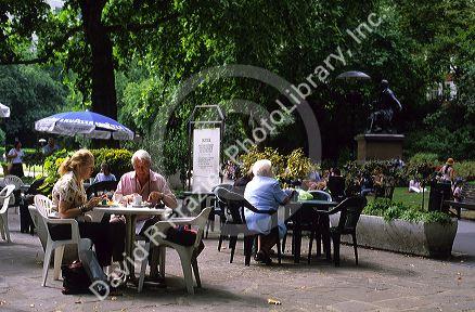 People having tea in the park, London, England.