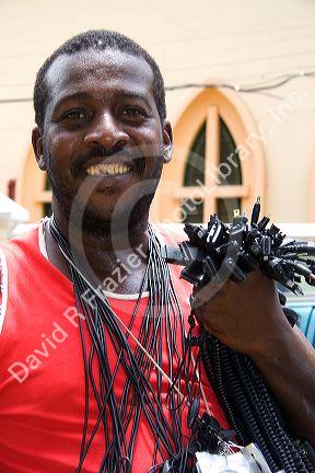 Street vendor in Rio de Janeiro, Brazil selling power cords for mobile telephones.