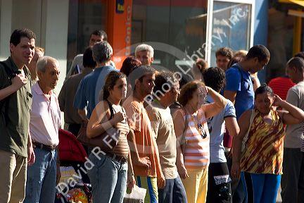 People waiting to cross the street in Rio de Janeiro, Brazil.