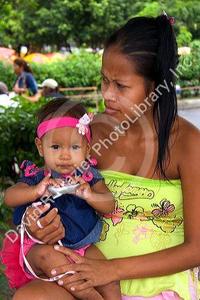 Brazilian woman holding her baby in Manaus, Brazil.