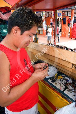 A man selling and repairing watches in Manaus, Brazil.