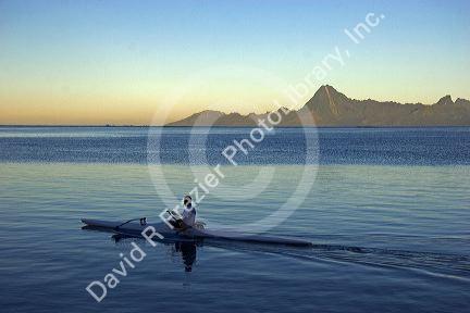 Outrigger canoe at sunrise off the island of Tahiti.  Moorea is in the background.