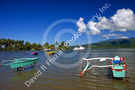 Outrigger canoes being stored on racks that sit above the lagoon at Tahiti Iti.