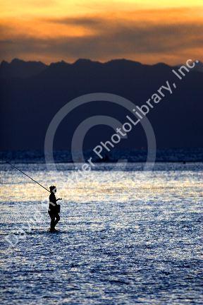 Fishing at sunset in the lagoon off the island of Tahiti.