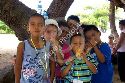 Children having sandwiches for lunch on the island of Moorea.