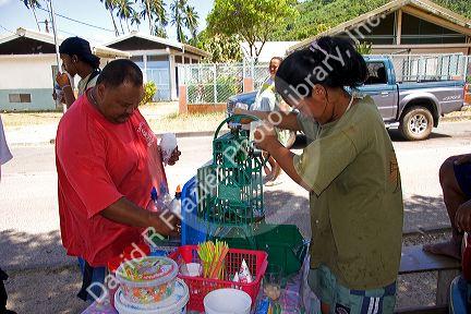 Woman making and selling shaved ice on the island of Moorea.