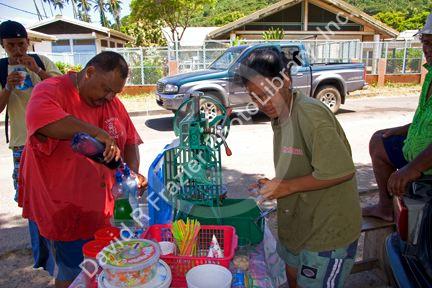 A woman making and selling shaved ice on the island of Moorea.
