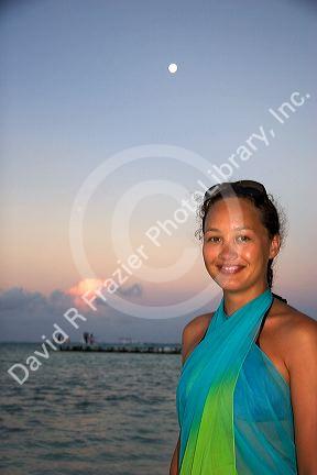 Woman on the beach at dusk on the island of Moorea. MR