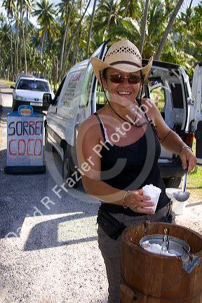 Tahitian woman selling coconut sorbet on the island of Moorea.