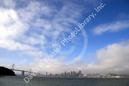 The Bay Bridge and San Francisco, California on a foggy morning.