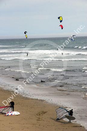 Parasurfing and windsurfers in the pacific ocean on the California coast.