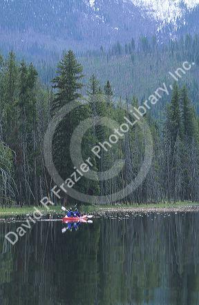 A couple kayaking on Warm Lake in the Boise National Forest, Idaho.