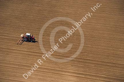 Aerial view of a farmer on a tractor spraying  a field in Canyon County, Idaho.