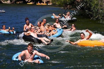 People on inflatable rafts floating the Boise River in Boise, Idaho.