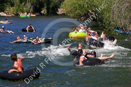People on tubes and inflatable rafts floating the Boise River in Boise, Idaho.