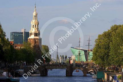 A view of the Amstel River, the Montelbaans Tower, and the NeMo in Amsterdam, Netherlands.