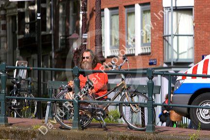 Man sitting on a park bench in Amsterdam, Netherlands.