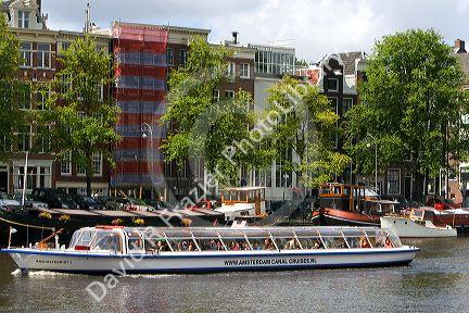 Tour canal boat on the Amstel River in Amsterdam, Netherlands.