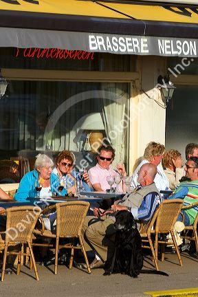 People dine at an outdoor cafe at Nieuwpoort in the province of West Flanders, Belgium.