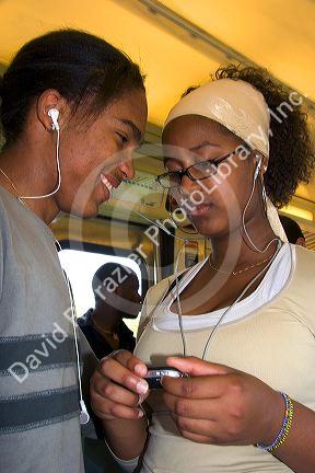 French students listen to an MP3 player on the train in Paris, France.