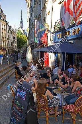 People dine outdoors at a cafe in Paris, France.