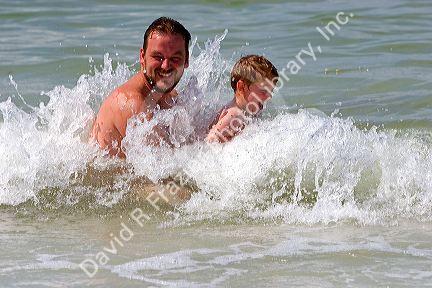 Father and son play in the water at St. Petersburg, Florida. MR