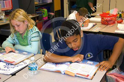 Fouth grade students read textbooks in a classroom at a public school in Tampa, Florida.