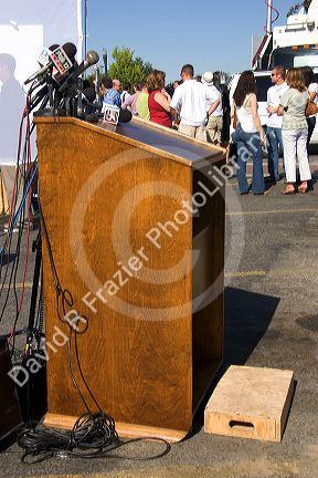 Podium with microphones at a press conference for Idaho Senator Larry Craig in Boise, Idaho.