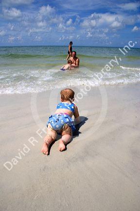 Infant crawling on the beach at St. Petersburg, Florida. MR