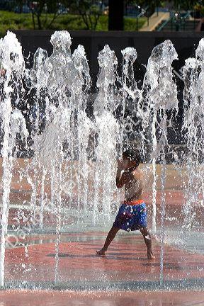 A child plays in the Fountain of Rings in Centennial Olympic Park, Atlanta, Georgia.
