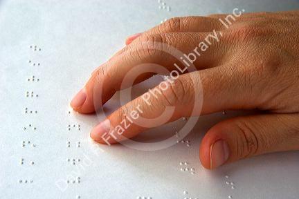 Hand reading braille.
