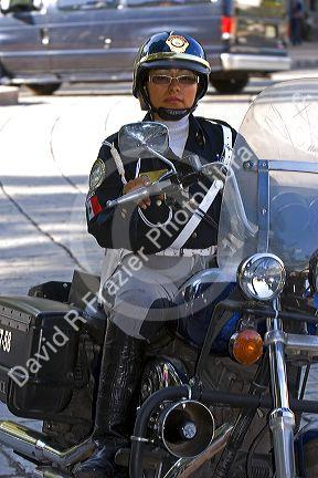 Female police officer riding a motorcycle in Mexico City, Mexico.