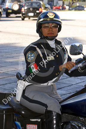 Female police officer riding a motorcycle in Mexico City, Mexico.