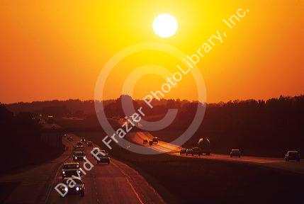 Automobiles traveling at sunset on Interstate 94 through Wisconsin.