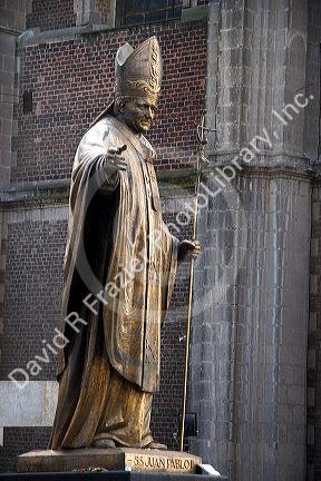 Statue made from melted brass keys of Pope John Paul II in front of the old Basilica of Guadalupe in Mexico City, Mexico.