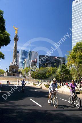 Bicyclists ride on the Paseo de la Reforma with no traffic on a Sunday in Mexico City, Mexico.