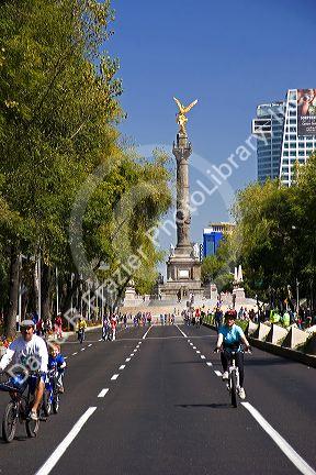 Bicyclists ride on the Paseo de la Reforma with no traffic on a Sunday in Mexico City, Mexico.