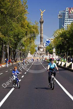 Bicyclists ride on the Paseo de la Reforma with no traffic on a Sunday in Mexico City, Mexico.