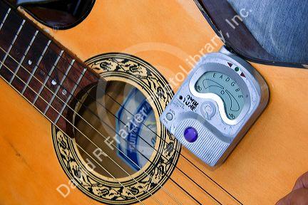 Acoustic guitar being tuned with an eletric tuner in Mexico City, Mexico.