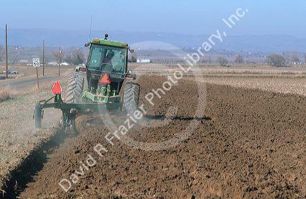 Farmer tilling his field with a tractor.