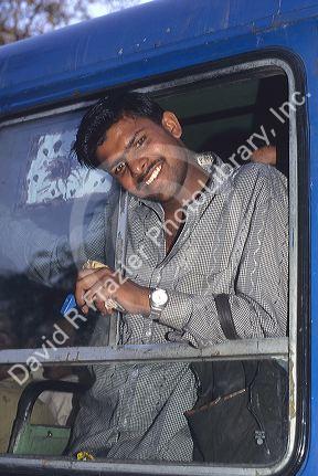 Bus conductor in New Delhi, India.