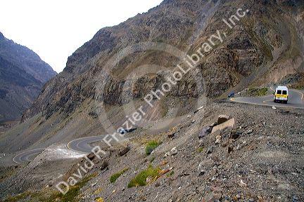 Vehicles drive on switchback roads in the Andes Mountain Range, Chile.