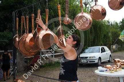 Roadside vendor selling copper pots and pans in rural Chile.