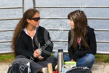 Girls socialize and drink mate at Ushuaia on the island of Tierra del Fuego, Argentina.