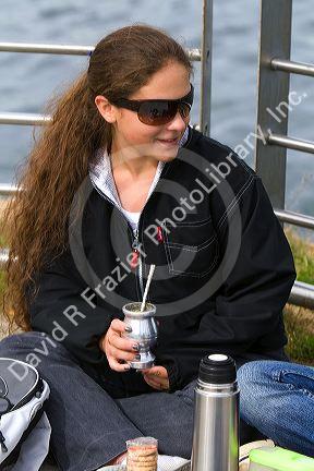 Girl drinking mate at Ushuaia on the island of Tierra del Fuego, Argentina.