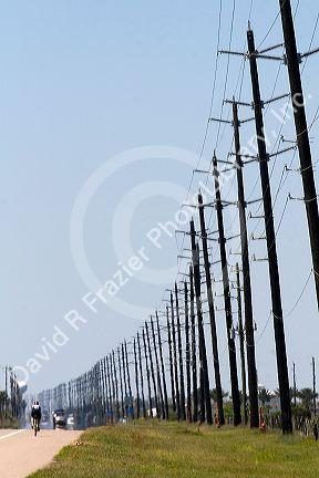 Utility poles line the highway on Galveston Island in Galveston, Texas.